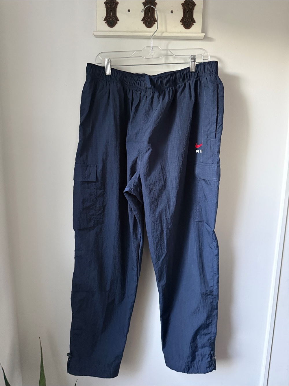 Nike Air Men’s Windbreaker Jogger in Navy Cargo Nylon Pants with Red Logo
